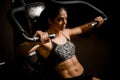 Close-up of woman doing exercises on simulator. Concept of sports, gyms, sportswear, fitness.