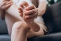 Close up of woman doing self foot massage for pain relief after fatigue, long walking, working, standing, flat feet or injury,