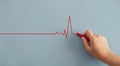 Close up Woman drawing heartbeat with red chalk on wall. Royalty Free Stock Photo