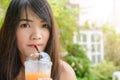 Close up of woman drinking ice tea from plastic cup with straw at cafe Royalty Free Stock Photo