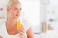 Close up of a woman drinking orange juice