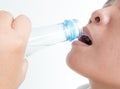 Close up woman drinking water from bottle on white background Royalty Free Stock Photo