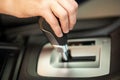 Close up of woman driver holding her hand on automatic gear shift stick driving as car Royalty Free Stock Photo