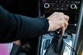 Close-up of woman driver holding her hand on automatic gear shift stick driving as car Royalty Free Stock Photo