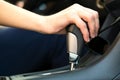 Close up of woman driver holding her hand on automatic gear shift stick driving as car Royalty Free Stock Photo