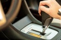 Close up of woman driver holding her hand on automatic gear shift stick driving as car Royalty Free Stock Photo