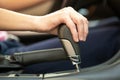 Close up of woman driver holding her hand on automatic gear shift stick driving as car Royalty Free Stock Photo