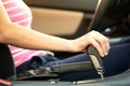 Close up of woman driver holding her hand on automatic gear shift stick driving as car Royalty Free Stock Photo