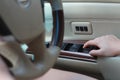 Close up woman driver`s hand pressing on button automatic power controlling window in car Royalty Free Stock Photo