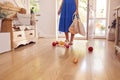 Close Up Of Woman Dropping Fresh Produce On Floor After Returning From Shopping Trip