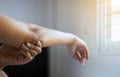 Close up of woman with dry skin on elbow and arm,Body and health care concept