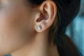 close-up of a woman ears with a pair of diamond earrings Royalty Free Stock Photo