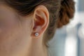 close-up of a woman ears with a pair of diamond earrings Royalty Free Stock Photo