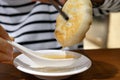 Close up woman eating beef potpie and dipping soup with spoon