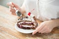 Close up of woman eating chocolate cherry cake Royalty Free Stock Photo