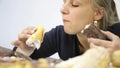 Close-up woman eating cupcakes with frenzy after debilitating diet