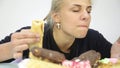 Close-up woman eating cupcakes with frenzy after debilitating diet