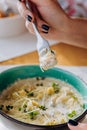 Close up of woman eating tasty Mussels in cheese sauce with dumplings served with greens Royalty Free Stock Photo