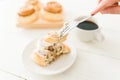 Close up of a woman enjoying a cinnamon roll with coffee Royalty Free Stock Photo