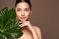 Close up woman face with green exotic leaf Royalty Free Stock Photo