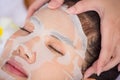 Close up woman face with mask in spa salon care. Young Asian girl relaxing with spa therapy. Beauty health lifestyle concept Royalty Free Stock Photo