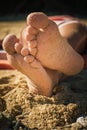 Close up of woman feet with sand at sunny beach Royalty Free Stock Photo