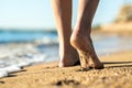 Close up of woman feet walking barefoot on sand leaving footprints on golden beach. Vacation, travel and freedom concept. People Royalty Free Stock Photo