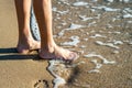 Close up of woman feet walking barefoot on sand leaving footprints on golden beach. Vacation, travel and freedom concept. People Royalty Free Stock Photo