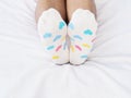 Woman feet wearing white sock with pastel heart shape pattern Royalty Free Stock Photo