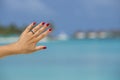 Close up of woman finger showing engagement ring on the tropical beach. Concept of people relationship, ring present, love  and Royalty Free Stock Photo