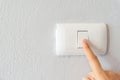 Close up of woman finger turning on light switch Royalty Free Stock Photo