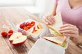 Close up of woman with food in plastic container Royalty Free Stock Photo