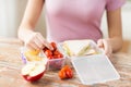 Close up of woman with food in plastic container Royalty Free Stock Photo