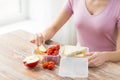 Close up of woman with food in plastic container Royalty Free Stock Photo