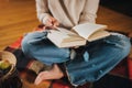 CLose up of Woman freelancer read book sitting in cozy glamping tent in autumn evening. Luxury camping tent for outdoor holiday