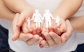 Close up of woman and girl hands with paper family Royalty Free Stock Photo