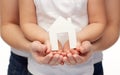 Close up of woman and girl hands with paper house Royalty Free Stock Photo