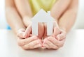 Close up of woman and girl hands with paper house Royalty Free Stock Photo