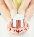 Close up of woman and girl hands with paper house Royalty Free Stock Photo