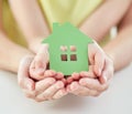 Close up of woman and girl hands with paper house Royalty Free Stock Photo