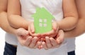 Close up of woman and girl hands with paper house Royalty Free Stock Photo