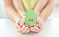 Close up of woman and girl hands with paper house Royalty Free Stock Photo