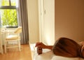 woman hand  in bedroom trying to wake up with alarm clock feeling Exhausted and overworked working in the night on the Royalty Free Stock Photo