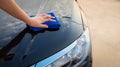 Close-Up of Woman Hand is Cleaning Her Car With Microfiber Cloth, Vehicle Service and Maintenance Concept