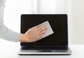 Close up of woman hand cleaning laptop screen