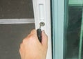 Close up woman hand hold house key with keyhole for front door entrance Royalty Free Stock Photo