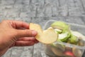 close up woman hand hold a piece of apple slice for healthy eating and diet