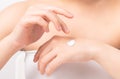 Close up of woman hand holding and applying moisturiser, Body lotion,  on white background. Royalty Free Stock Photo