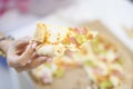 Woman hand holding big fat piece of delicious hot pizza Royalty Free Stock Photo