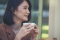 Close up Woman hand holding black coffee cup in green garden cafe. Hands of businesswoman love drinking hot coffee. business women Royalty Free Stock Photo